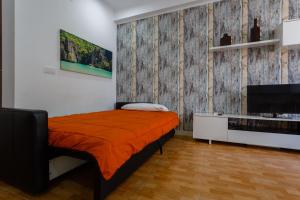 加的斯Apartamentos El BALNEARIO by Cadiz4Rentals的一间卧室配有一张带橙色毯子的床
