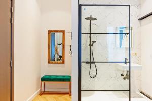 布鲁塞尔Hotel Les Ecrins的带淋浴和绿色凳子的浴室