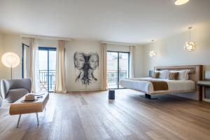 卡尔维KASANO & Spa的一间卧室配有一张床和一张画作,有两位女性