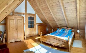 鲁比亚托沃KASZUBSKA CHATA的木制阁楼卧室配有一张床