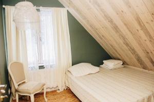 LimuLoovälja Guesthouse的卧室配有床、椅子和窗户。