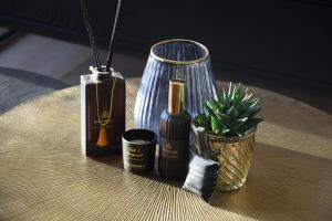 ZulteCaCeLe Raveelzicht的一张桌子,上面有香水瓶和盆栽植物