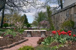 埃尔克哈特埃尔克哈特红屋顶客栈的花园里的石头长凳,花丛中