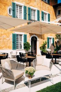 萨罗博尔戈伊尔迈扎尼诺农家乐的庭院配有桌椅和遮阳伞。