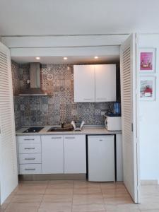阿尔库迪亚Cozy estudio "Edificio Siesta 2"的厨房配有白色橱柜和水槽