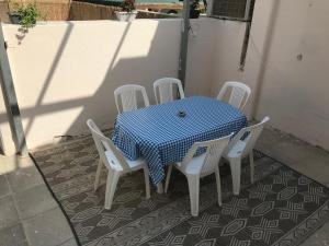 尼夫佐哈QUEEN of the dead sea by CROWN的一张桌子、白色椅子和蓝白色的桌布