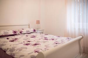 雅西Căsuța din Copou的一间卧室,床上有紫色鲜花