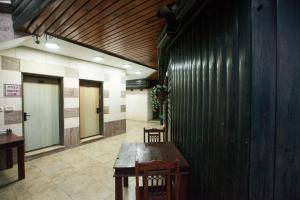 提比里亚מלון אחוזת האושר的大楼内带木桌和椅子的走廊