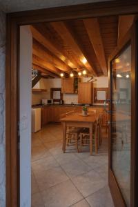PolcenigoAlbergo Diffuso Polcenigo Casa Blas的厨房以及带木桌的用餐室。