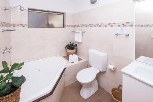 莫里莫科Mollymook Seascape Motel and Apartments的浴室配有卫生间、盥洗盆和浴缸。