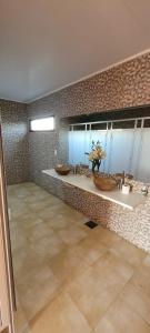 乌拉圭河畔康塞普西翁El Coronillo - Lodge的大型浴室设有两个盥洗盆和大窗户。