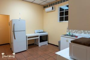 圣伊格纳西奥Yellow Belly Backpackers的厨房配有白色冰箱和炉灶。