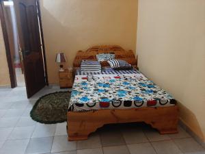巴马科Appartement Villa的一间卧室,卧室内配有一张木床