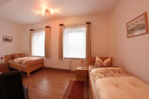 哥达帕松姆奥斯巴霍夫旅馆的一间卧室设有两张床和两个窗户。