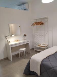 罗萨里奥港Casa Guanche的一间卧室配有一张床、一张书桌和一面镜子