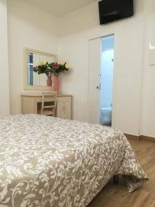 阿尔巴·阿德里亚蒂卡Hotel Flora的一间卧室配有一张带棕色和白色床罩的床。