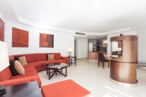 洛斯克里斯蒂亚诺斯Atlas Suites Tenerife by EnjoyaHome的客厅配有红色的沙发和桌子