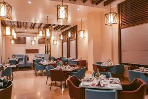 JagdalpurHOTEL AVINASH INTERNATIONAL的用餐室配有桌椅和灯光