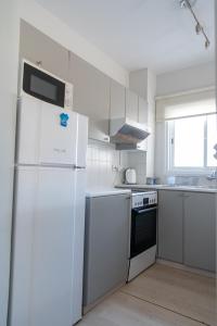 沃罗里尼Kypkeys Apartments的厨房配有白色家电和白色冰箱