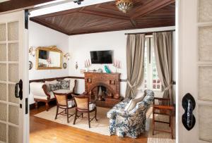 圣玛尔塔迪佩纳吉昂Casa do Salgueiral的客厅设有壁炉、桌子和椅子
