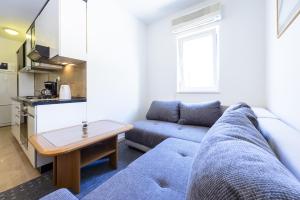 杜布罗夫尼克Apartment Tija的客厅配有蓝色的沙发和桌子
