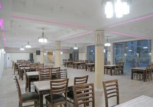 布哈拉Grand Ark Bukhara的用餐室设有桌椅和窗户。