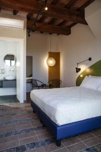 MusignanoIl Poggio di Musignano的卧室配有一张床和一张桌子及椅子