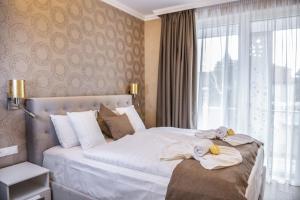 赫维兹Spa Residence Carbona Apartment 105的酒店客房,配有带毛巾的床