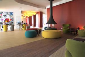 尼姆HÔTEL C SUITES chambres spacieuses的大堂设有色彩缤纷的椅子和桌子