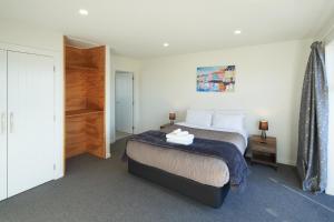 特卡波湖Alpine View Apartment 3 - Tekapo的一间卧室配有一张床和一个衣柜