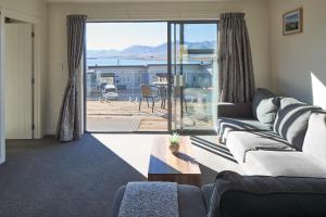 特卡波湖Alpine View Apartment 3 - Tekapo的带沙发的客厅,享有海景