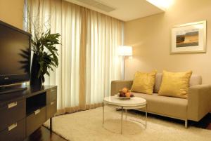 曼谷曼谷沙吞路耐拉提瓦斯公寓酒店的客厅配有沙发和桌子