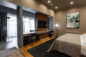 别尔哥罗德Riviera Wellness Resort的配有一张床和一张书桌的酒店客房