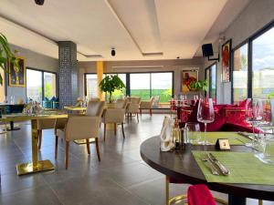 阿比让BNB Hotel Spa的用餐室设有桌椅和窗户。