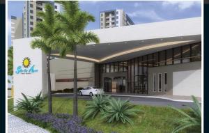 奥林匹亚Solar das Águas Park Resort Olímpia的一座带汽车的建筑前的棕榈树