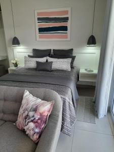约翰内斯堡Kent Manor Guest Suites的一间卧室配有一张大床和一张沙发