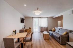 马莱斯韦诺斯塔Margun - Apartments & PanoramaRooms的客厅配有沙发和桌子