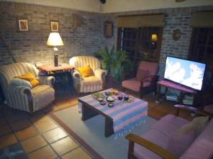 库奇拉阿尔塔Posada 5a. Reverie的客厅配有椅子、桌子和电视