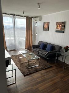 圣地亚哥Views Cordillera的带沙发和玻璃桌的客厅