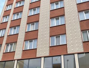 伯萨Bursa Malkoc Hotel的一座高大的砖砌建筑,有许多窗户