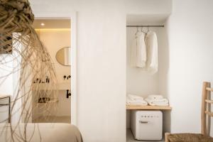休达德亚Meloussa Boutique Hotel的卧室设有白色墙壁、一张床和一个衣柜。