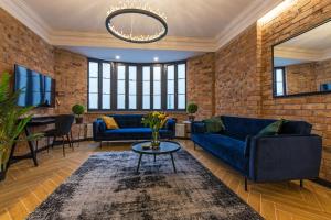 弗罗茨瓦夫Galeria Italiana Apartments的客厅配有蓝色的沙发和桌子