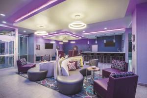 拉伯克La Quinta by Wyndham Lubbock South的紫色的大堂设有椅子和酒吧