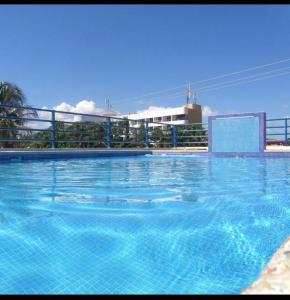 El YaqueHotel Posada La Mar的大楼前的蓝色海水大型游泳池