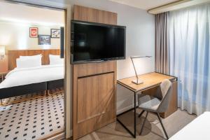 卑尔根卑尔根皇家丽笙酒店的配有一张床和一台平面电视的酒店客房