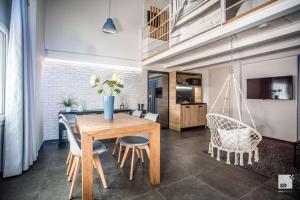 博洛尼亚Pam Style Home的一间带木桌和椅子的用餐室