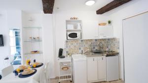 阿维尼翁Charmant studio 25 m2 centre ville Avignon的小厨房配有白色橱柜和水槽
