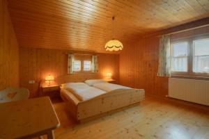 法斯奇纳Lari Fari的木制客房内的一间卧室,配有一张床