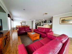 巴瑟尔顿Hideaway By the Bay的客厅配有红色的沙发和桌子