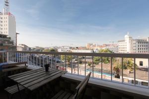 米兰DADA 2bd App - nuovo in CENTRO zona Navigli的阳台设有木凳,享有城市美景。